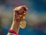 hand-woman-raising-olympic-gold-medal-victory